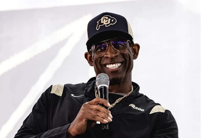 Deion Sanders smiling at CU's kickoff luncheon on Aug. 25